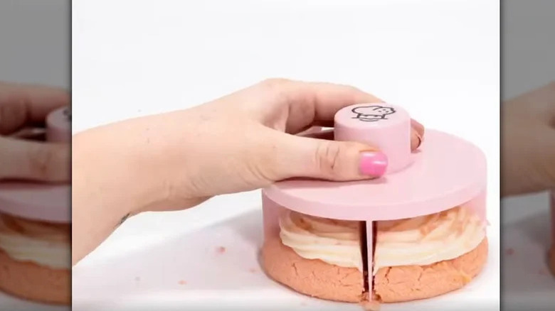 person cutting cookie with Crumbl cookie cutter