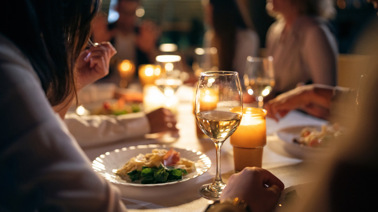 People eating by candlelight 