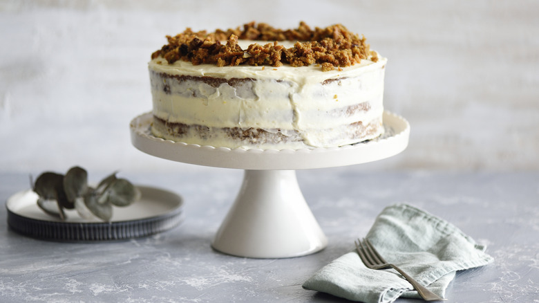 Carrot cake with nuts on white cake stand