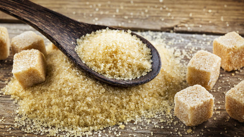 Brown sugar with cubes and a spoon