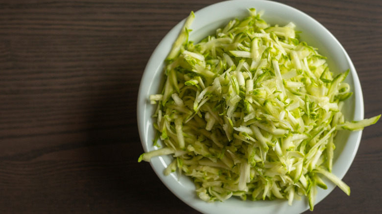 Shredded zucchini in white bowl