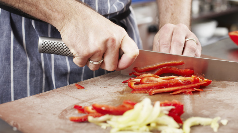 Chef cutting peppers