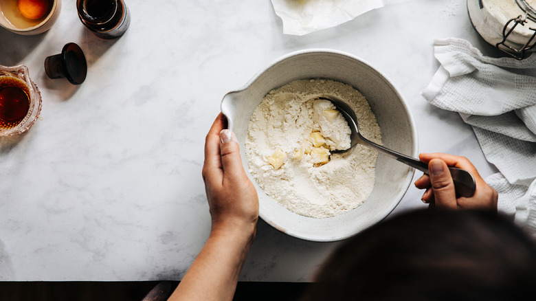 Person mixing ingredients in bowl