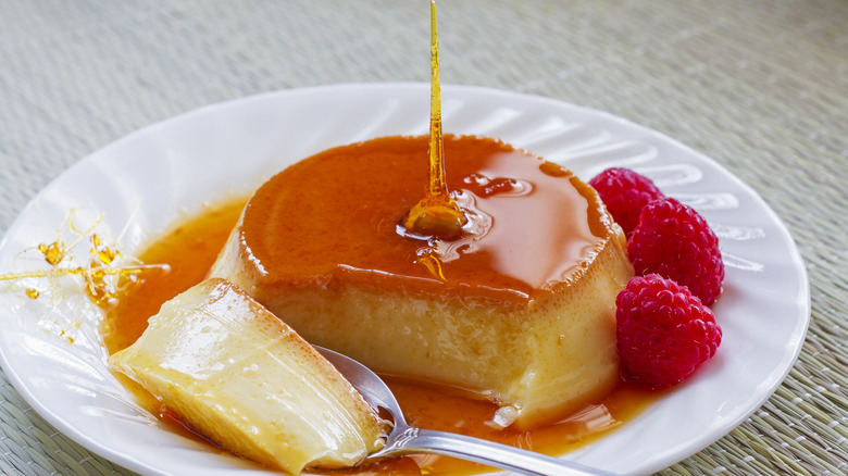 Flan dessert on plate with raspberries