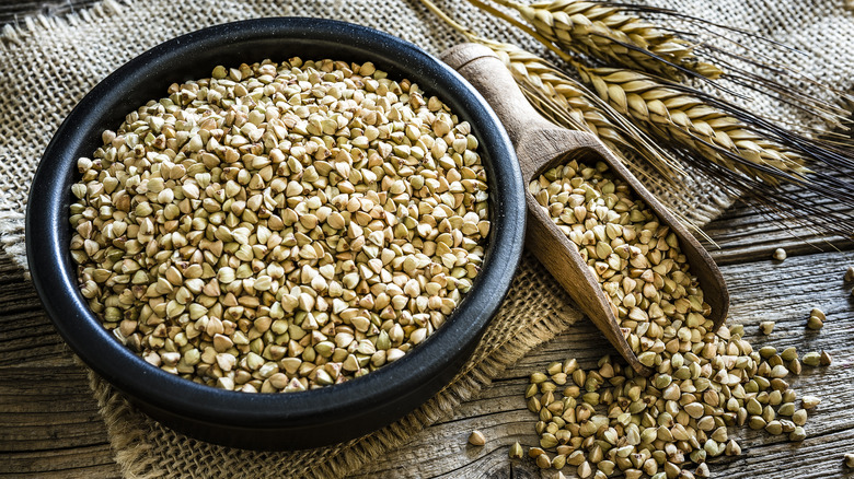 whole buckwheat in wooden bowl