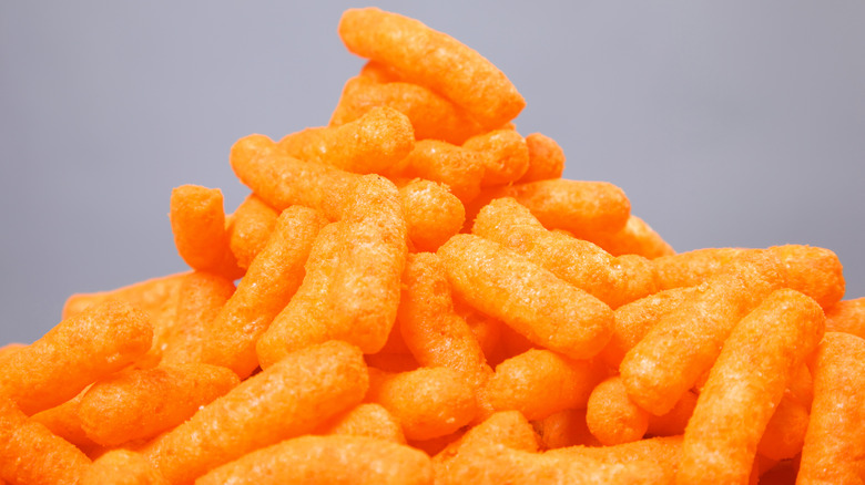 Stack of Cheetos on background