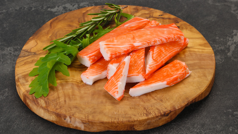 Crab stick surimi over wooden board