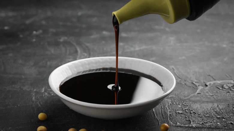 Soy sauce poured in saucer