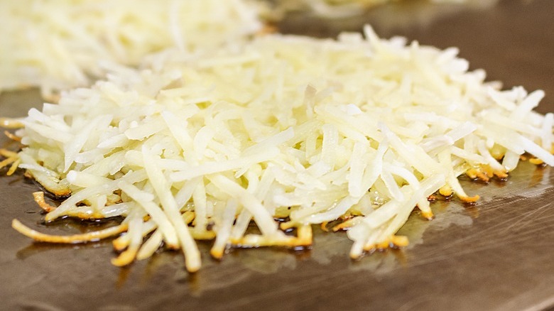 Shredded potatoes on a grill