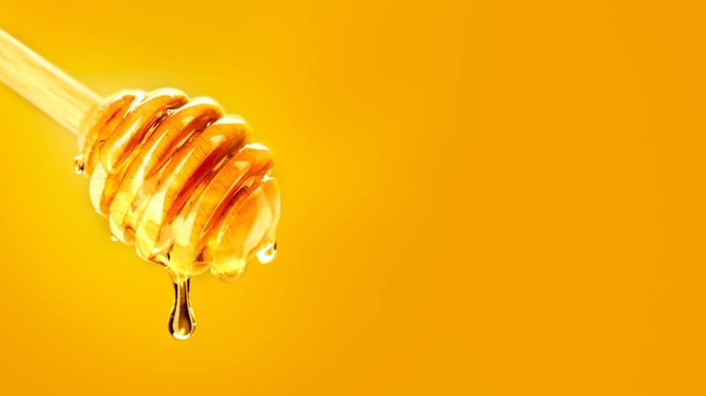 Honey drizzle on yellow background