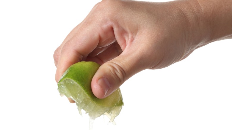 Hand squeezing lime