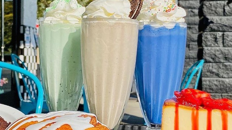 Colorful milkshakes with desserts