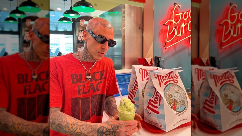 Travis Barker holding a Travis' oat matcha latte 