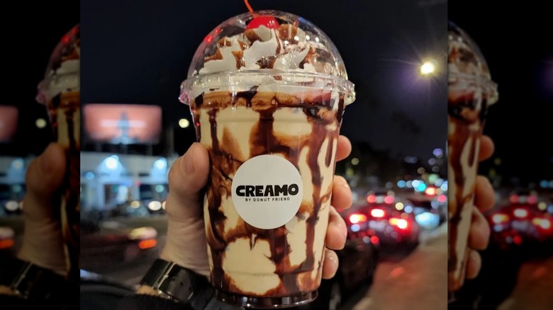 Man holding two Creamo milkshakes