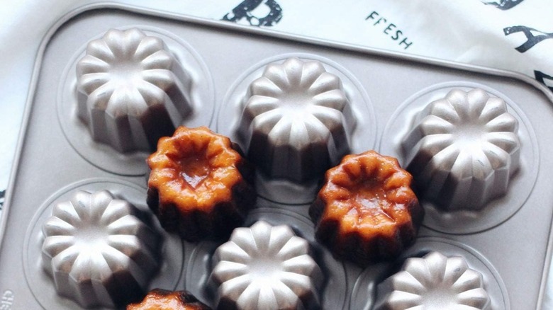 Silver non-stick pan with baked caneles