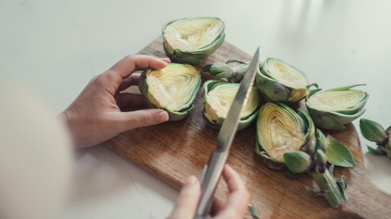 Person cutting artichokes