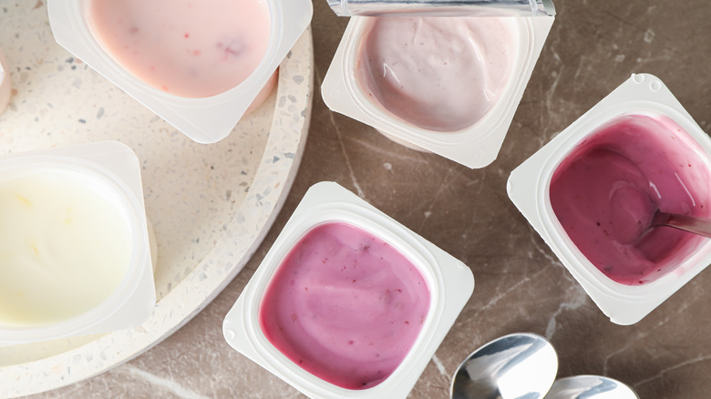 Plastic yogurt cups on table