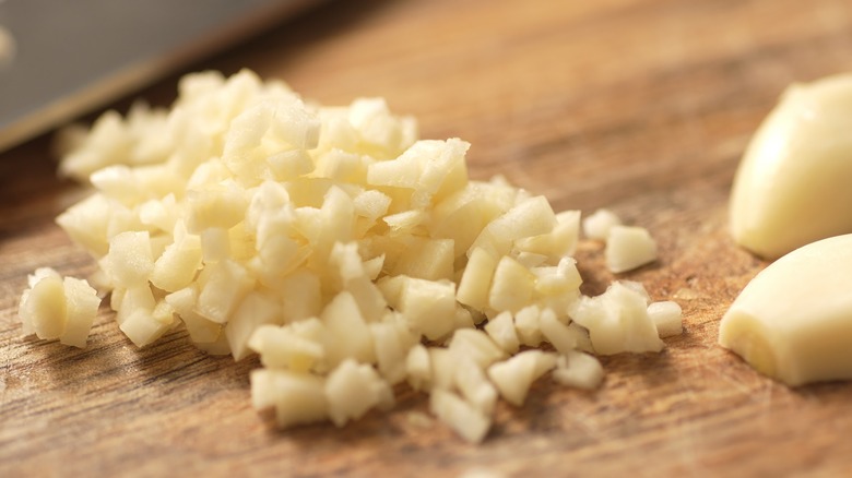 Freshly minced garlic on a cutting board