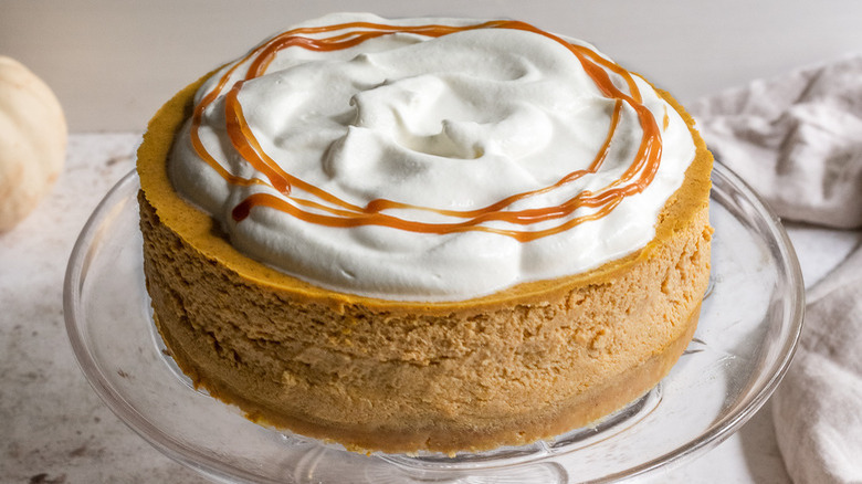 whole pumpkin cheesecake on stand