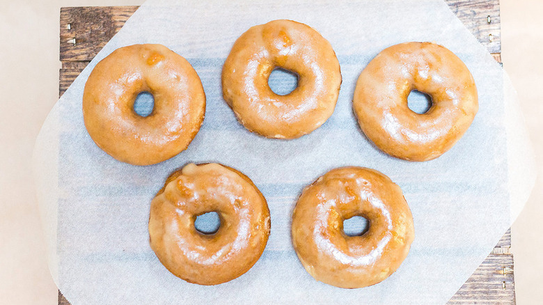 glazed doughnuts on parchment paper