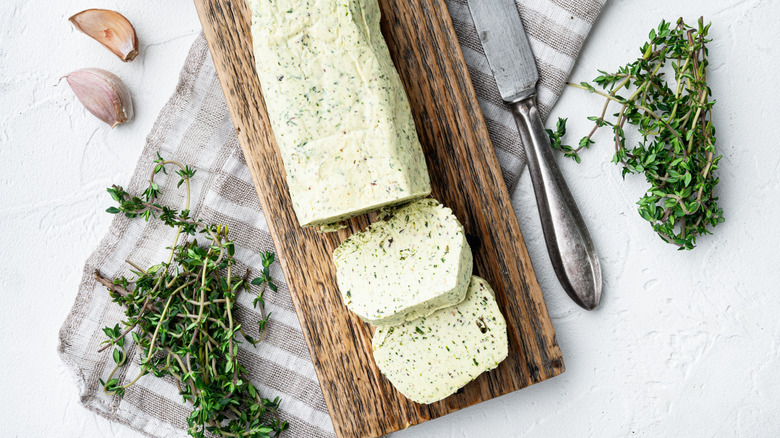 Rosemary thyme herb compound butter is sitting in a dish.