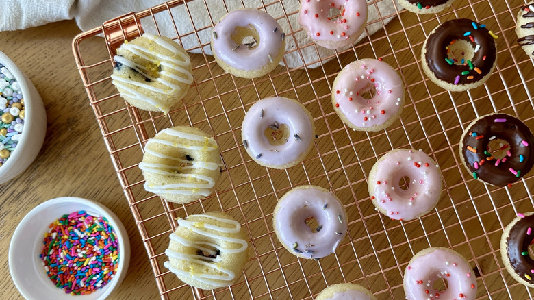 Mini donuts with various designs on wire rack
