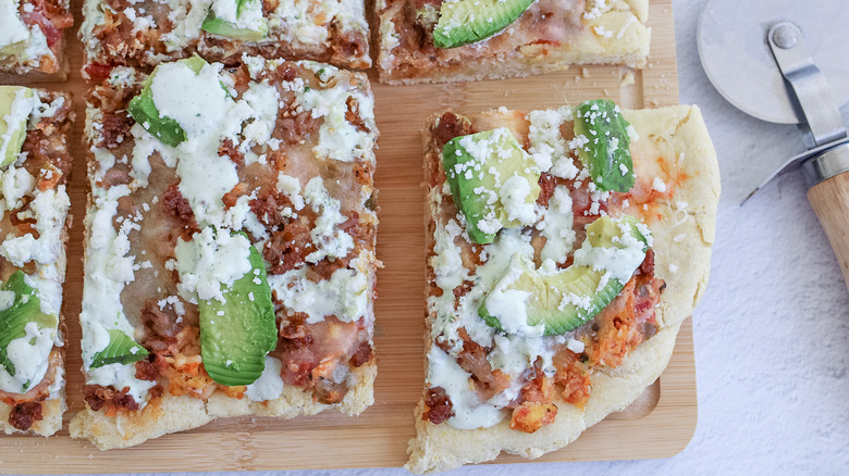 Breakfast pizza slices with avocado and cheese