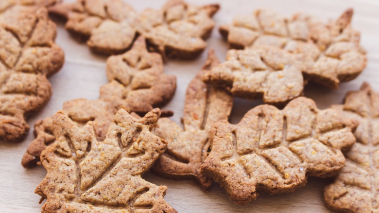 Autumnal maple leaf cookies on wooden table