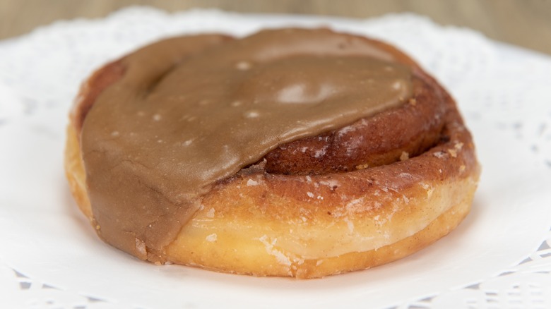 Maple butter-glazed cinnamon roll on plate