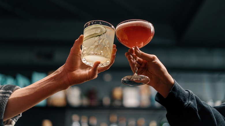 People clinking cocktail glasses