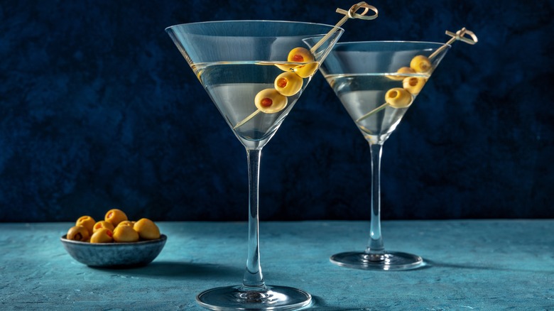 Two martinis with olives 