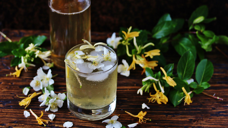 Drink garnished with jasmine and honeysuckle blooms.
