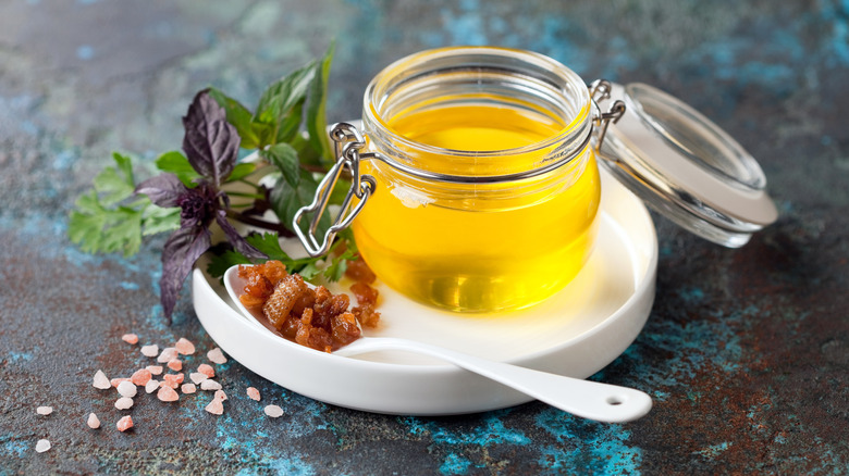 Duck fat in a glass jar on table