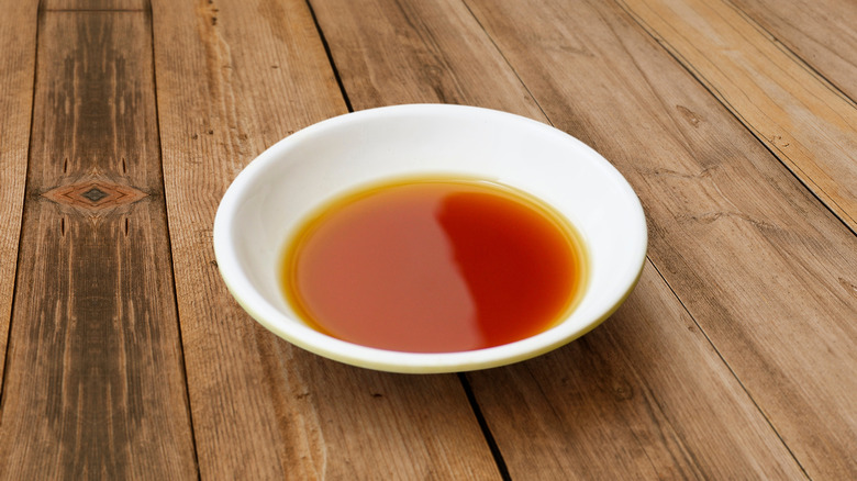 Bowl of fish sauce on wooden table