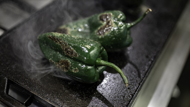 Charred poblano peppers on grill