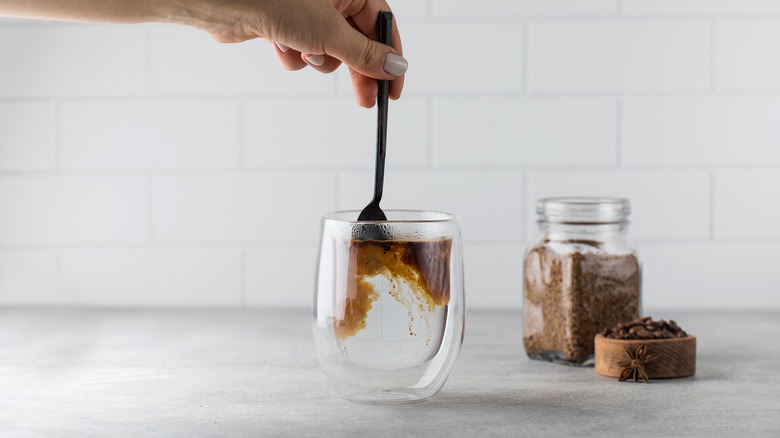 Stirring coffee with spoon