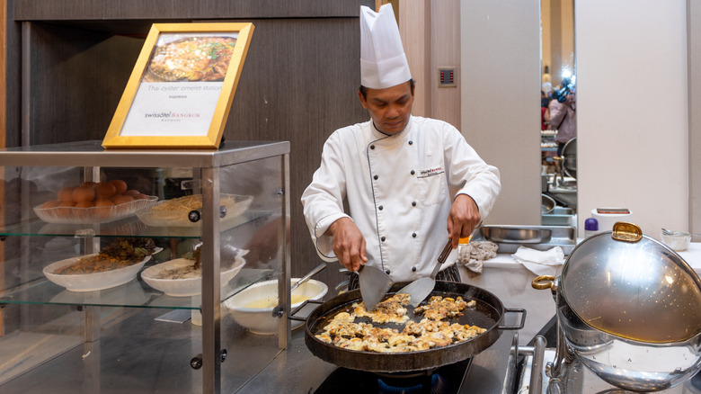 chef preparing oyster omelet at live cooking station