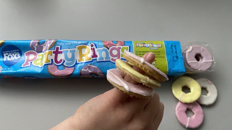 Child's hand wearing party rings biscuits