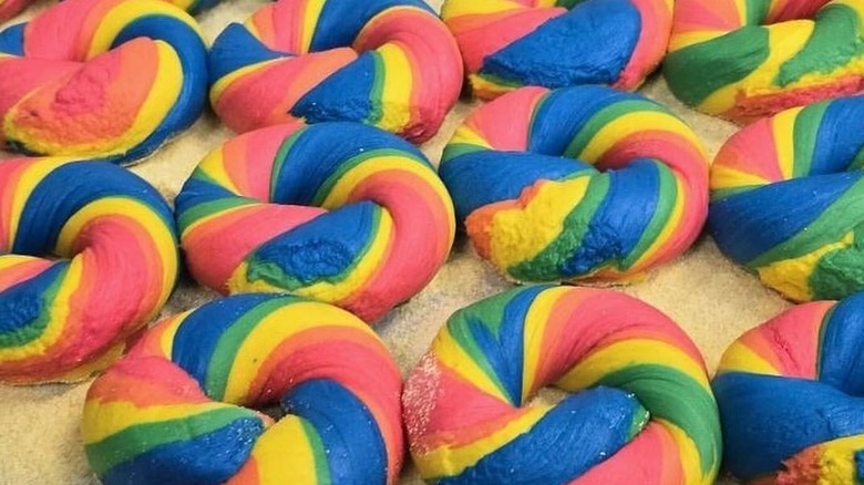 Dozens of rainbow-colored bagels