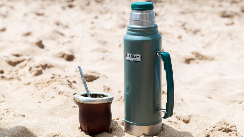 Stanley container on sandy beach