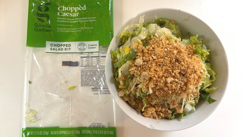 Good & Gather Chopped Caesar Salad Kit in white bowl next to package on white table