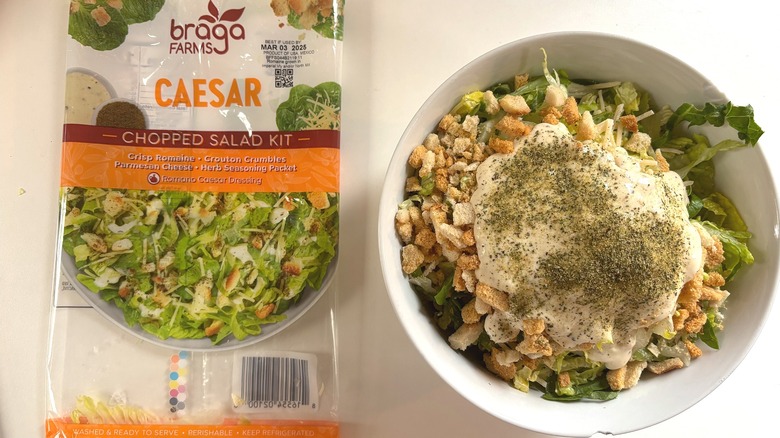 Braga Farms Caesar Chopped Salad Kit in white bowl next to package on white table