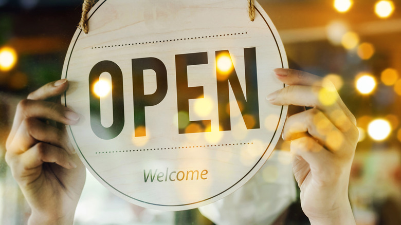 open sign being turned restaurant