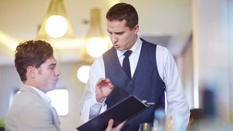 server explaining something to diner