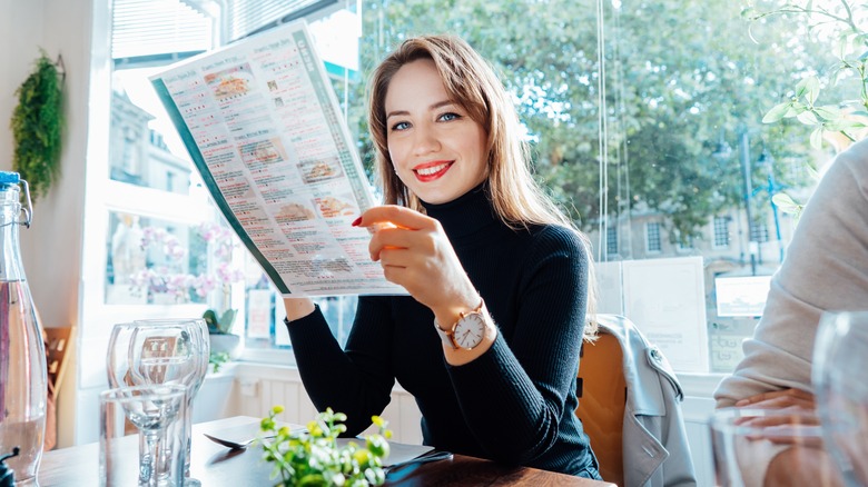 woman smiling with menu