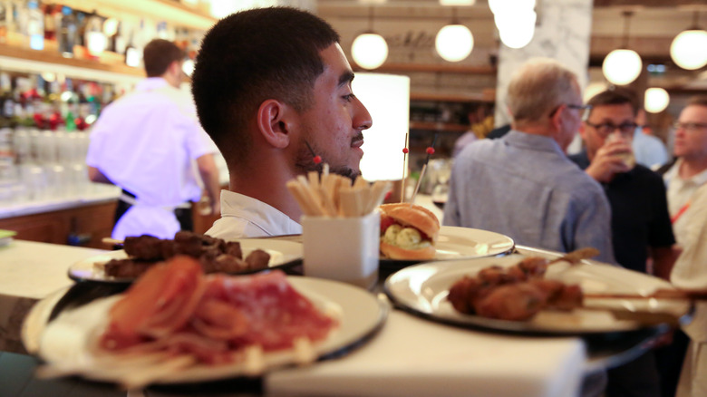 server carrying small plates food