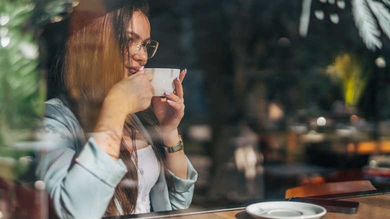 woman at window with coffee