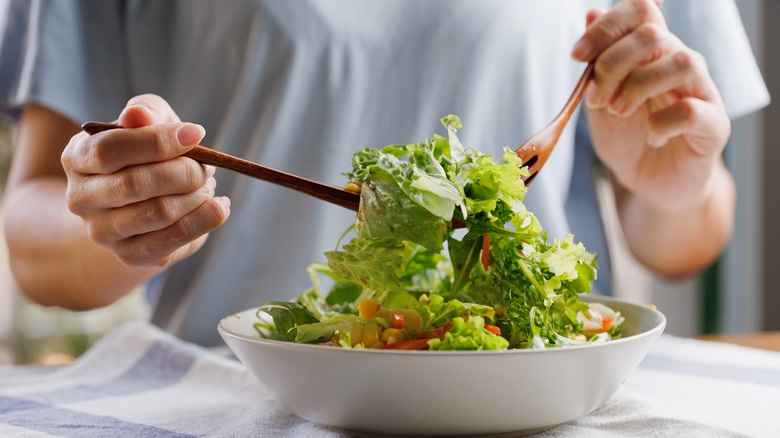 Person eating a salad