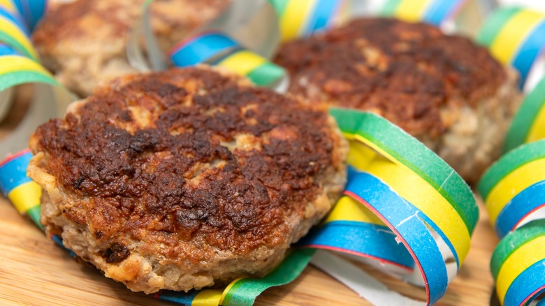 Meat patties resting on colorful streamers 