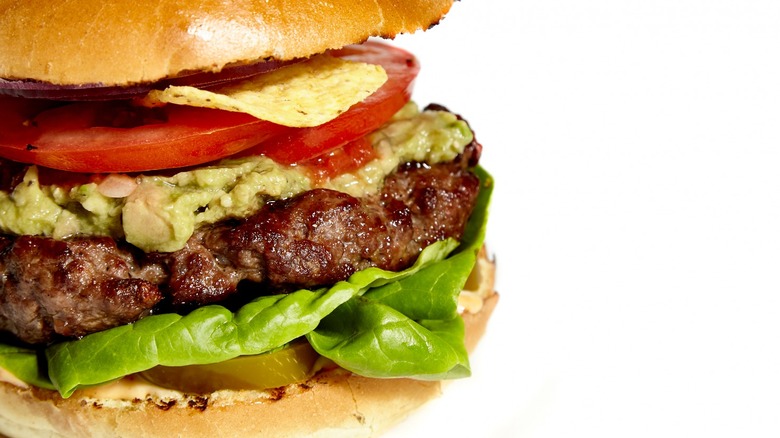 Hamburger with guacamole in white background